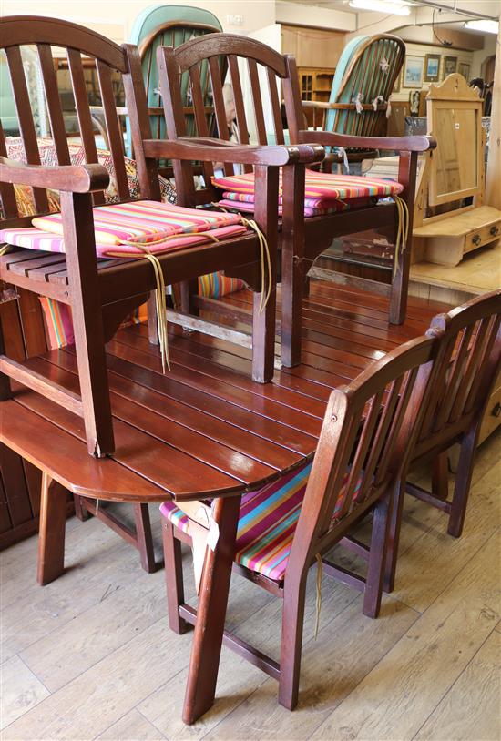 A teak folding garden table and six chairs W.166cm